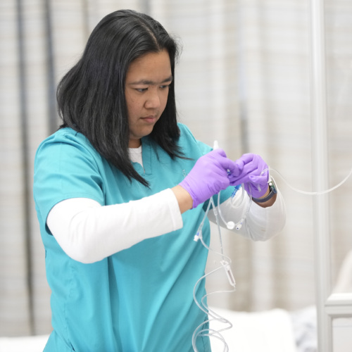 HCCC program participant adjusting an IV bag